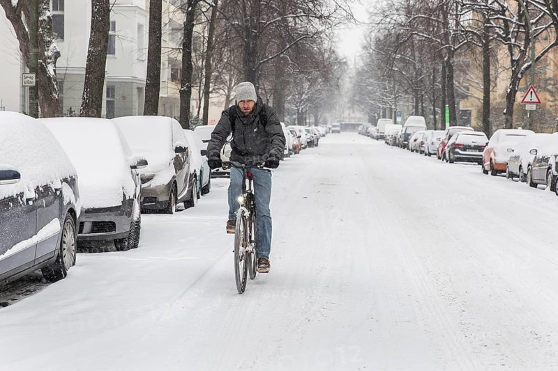 DEU Germany Germany Berlin Cyclists on snow-covered road in Schöneberg
