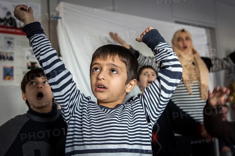 DEU Germany Germany Berlin An animation team entertains refugee children in an asylum center in Berlin