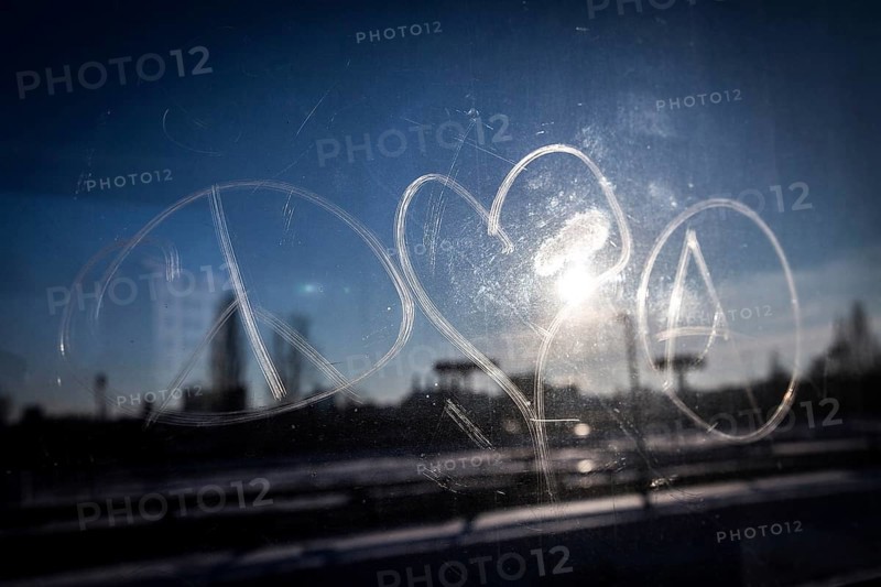 DEU Germany Germany Berlin The symbols of peace, love and anarchy are carved on the window of an S-Bahn. In backlight, they are constant companions on the ring railway towards Schöneberg