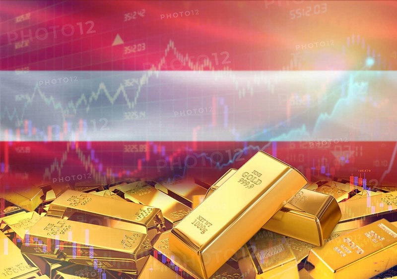 Gold bars on Austria flag in background. Gold bars stacked on Austrian flag. Concept of Austria gold reserves