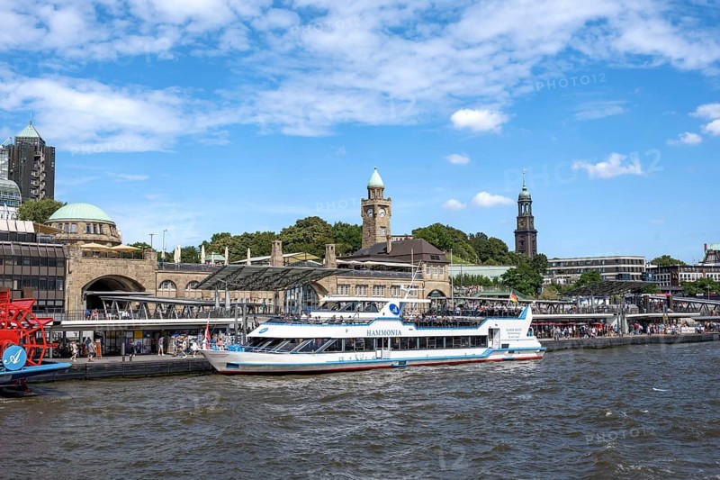 Elbe and boats at St. Pauli Landungsbrücken, historic building with water level tower, Hamburg, Germany