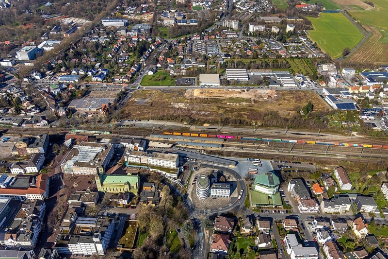 Aerial view, Unna railway station, Viktoriastrasse construction area for office building, St. Catherine's Catholic Church, Unna town hall, Unna, Ruhr area, North Rhine-Westphalia, Germany. Katharina, Unna town hall, Unna, Ruhr area, North Rhine-Westphalia, Germany, place of worship, railway station, Bahnhofstraße, station forecourt, construction area, building site, building plots, construction project, construction site, authority, bus station, container train, DE, Deutsche Bahn AG, development, Europe, religious community, house of worship, capacity requirement, church, parish, denomination, aerial view, aerial photography, aerial photography, new building, town hall, town hall square, religion, suburban railway, city administration, overview, administrative area, bird's-eye view, birds-eyes view, former Hildebrand plough factory, overview