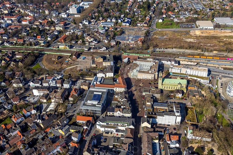 Aerial view, Unna railway station, Viktoriastrasse construction area for office building, St. Catherine's Catholic Church, Unna town hall, Unna, Ruhr area, North Rhine-Westphalia, Germany. Katharina, Unna town hall, Unna, Ruhr area, North Rhine-Westphalia, Germany, place of worship, railway station, Bahnhofstraße, station forecourt, construction area, building site, building plots, construction project, construction site, authority, bus station, container train, DE, Deutsche Bahn AG, development, Europe, religious community, house of worship, capacity requirement, church, parish, denomination, aerial view, aerial photography, aerial photography, new building, town hall, town hall square, religion, suburban railway, city administration, overview, administrative area, bird's-eye view, birds-eyes view, former Hildebrand plough factory, overview