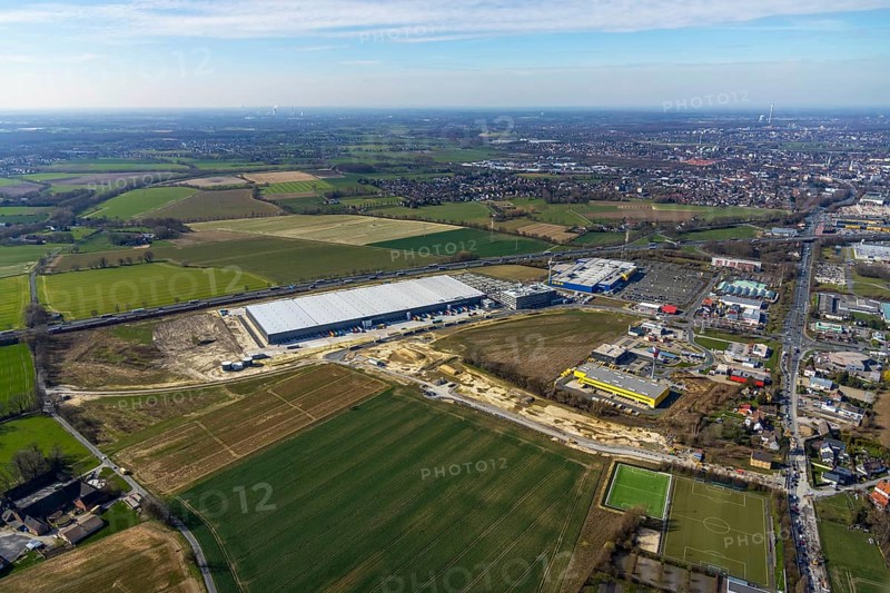 Aerial view, new Woolworth headquarters and logistics centre, commercial area Unna Kamen, Ikea, Unna, Ruhr area, North Rhine-Westphalia, Germany, A1 motorway, DE, Europe, commercial enterprises, commercial area, commercial park, commercial location, commercial use, freight traffic, industrial area, industrial location, logistics, logistics centre, aerial view, aerial photography, aerial photography, overview, bird's-eye view, meadows and fields, birds-eyes view, overview