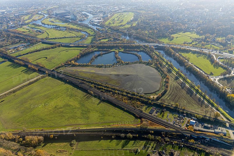 Aerial view, sewage sludge landfill at Styrumer Ruhrbogen, Ruhr meadows, river Ruhr, Mülheim an der Ruhr, Ruhr area, North Rhine-Westphalia, Germany, bridge over the Ruhr, DE, landfill, railway bridge, Europe, distant view, flood, aerial view, aerial photography, aerial photography, Ruhr floodplain, Ruhr valley cycle path, Ruhr riverbank, Speldorfer Straße, overview, bird's-eye view, wind turbine, wind energy, wind energy plant, wind power, wind turbine, wind turbines, birds-eyes view, overview, flooding
