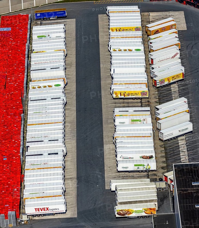 Aerial view, Corona at Tönnies, headquarters of Fleischfabrik Tönnies Lebensmittel GmbH & Co. KG, Nordrheda-Ems, Rheda-Wiedenbrück, Ostwestfalen, North Rhine-Westphalia, Germany, DE, Europe, birds-eyes view, aerial view, aerial photography, aerial photography, overview, bird's eye view, corona outbreak at Tönnies meat factory, air cooling, cutting plant, slaughterhouse, lock-down, corona pandemic, pandemic, don't call it Schnitzel, Tillmans, Tillman's, lorry trailer, refrigerated trailer, company closure