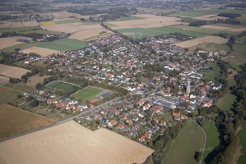 Aerial view, view of the town, St. Stephanus Kirche, Oestinghausen, Lippetal, Kreis Soest, North Rhine-Westphalia, Germany, Aldi Supermarkt Neubau, Andachtstätte, DE, Europa, Fußballplatz, Fußballstadion, Fußballverein, Glaubensgemeinschaft, Gotteshaus, Grundsteuer, Immobilien, Kirche, Kirchengemeinde, Konfession, Kreis-Soest-Buch, KreisSoestBuch, aerial view, aerial photography, aerial photography, religion, sports, sports facilities, sports field, sports facility, stadium, townscape, urban area, overview, bird's-eye view, meadows and fields, residential area, housing and living, residential area, residential buildings, residential quality, residential neighbourhood, housing estate, birds-eyes view, overview