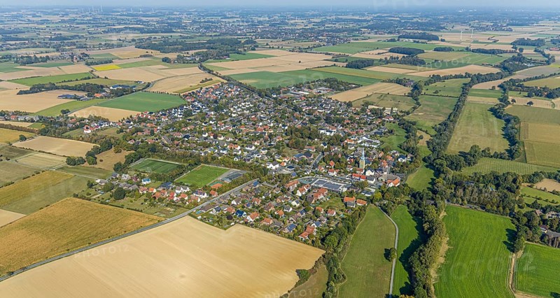 Aerial view, view of the town, St. Stephanus Kirche, Oestinghausen, Lippetal, Kreis Soest, North Rhine-Westphalia, Germany, Aldi Supermarkt Neubau, Andachtstätte, DE, Europa, Fußballplatz, Fußballstadion, Fußballverein, Glaubensgemeinschaft, Gotteshaus, Grundsteuer, Immobilien, Kirche, Kirchengemeinde, Konfession, Kreis-Soest-Buch, KreisSoestBuch, aerial view, aerial photography, aerial photography, religion, sports, sports facilities, sports field, sports facility, stadium, townscape, urban area, overview, bird's-eye view, meadows and fields, residential area, housing and living, residential area, residential buildings, residential quality, residential neighbourhood, housing estate, birds-eyes view, overview