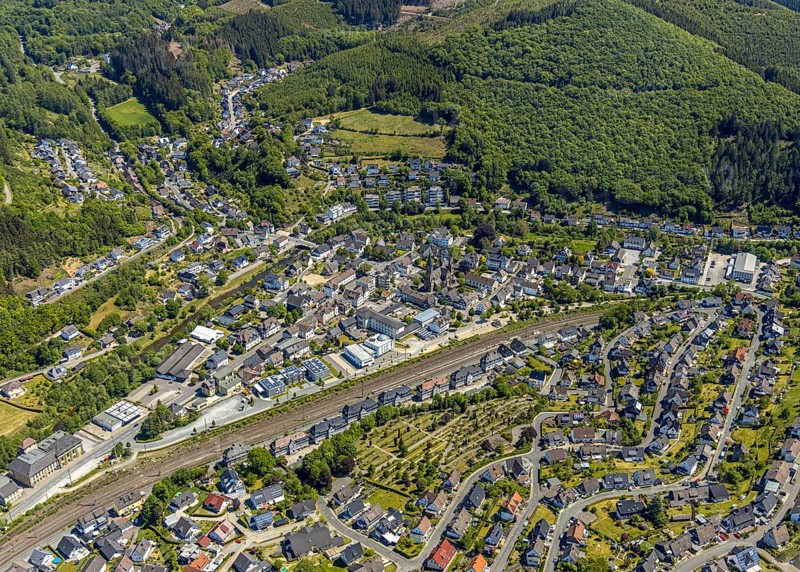 Aerial view, view of Meggen, Lennestadt-Meggen railway station, Rayonex Biomedical GmbH, Franziskus-Schule Meggen, DITIB Yesil Mosque Lennestadt, Catholic Church St. Bartholomäus, Lennestadt, Sauerland, North Rhine-Westphalia, Germany, place of worship, railway tracks, railway station, burial site, education, educational institution, DE, Deutsche Bahn AG, Europe, cemetery, Meggen cemetery, Schützenhof restaurant, memorial, religious community, place of worship, place of worship, property tax, cemetery, real estate, church, parish, denomination, educational institution, aerial view, aerial photography, aerial photography, resting place, school, overview, bird's-eye view, housing estate, housing and living, residential area, residential buildings, housing quality, housing estate, birds-eyes view, overview, wladg