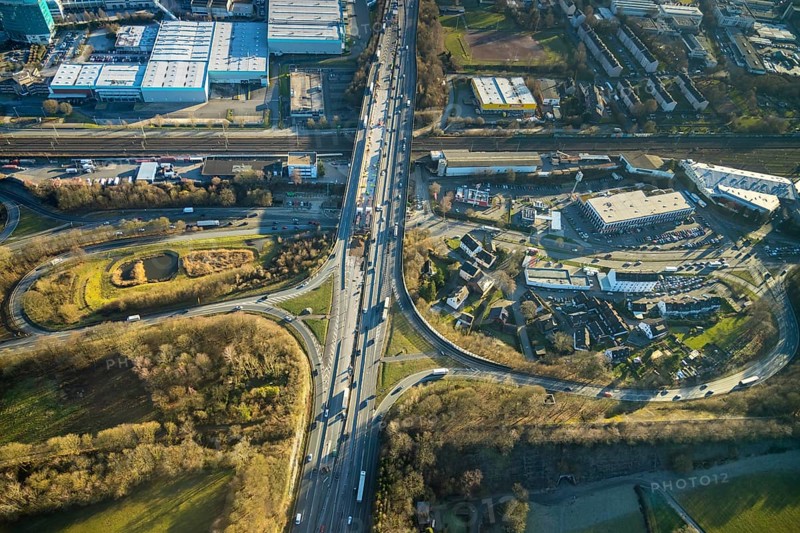 Aerial view, motorway A1, motorway bridge over the Talstraße, motorway junction Wuppertal-Langerfeld, city limits Wuppertal, Schwelm, Ruhr area, North Rhine-Westphalia, Germany, motorway A1 over the federal road B7 Talstraße, motorway bridge, railway tracks, railway line, railway tracks, bridge, federal road B7, DE, Europe, commercial area, commercial area, commercial use, industrial area, industrial site, aerial view, aerial photography, aerial photography, overview, bird's eye view, birds-eyes view, overview