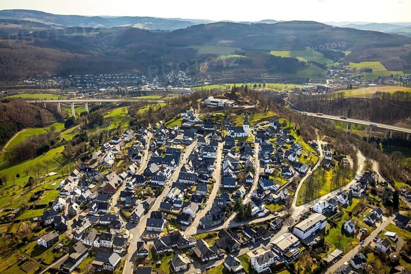 Aerial view, view of Eversberg, ruins of Eversberg Castle, Schlossberghalle Eversberg, St.-Johannes-Evangelist-Kirche, Eversberg, Meschede, Sauerland, North Rhine-Westphalia, Germany, castle, DE, Europe, half-timbered houses, religious community, place of worship, property tax, hilly landscape, real estate, church, parish, denomination, aerial view, aerial photography, aerial photography, Arnsberg Forest nature park Park, religion, ruins, castle, castle hill, overview, event location, event venue, bird's-eye view, meadows and fields, residential area, living and life, residential area, residential buildings, residential quality, residential neighbourhood, housing estate, bird's-eye view, cultural use, overview