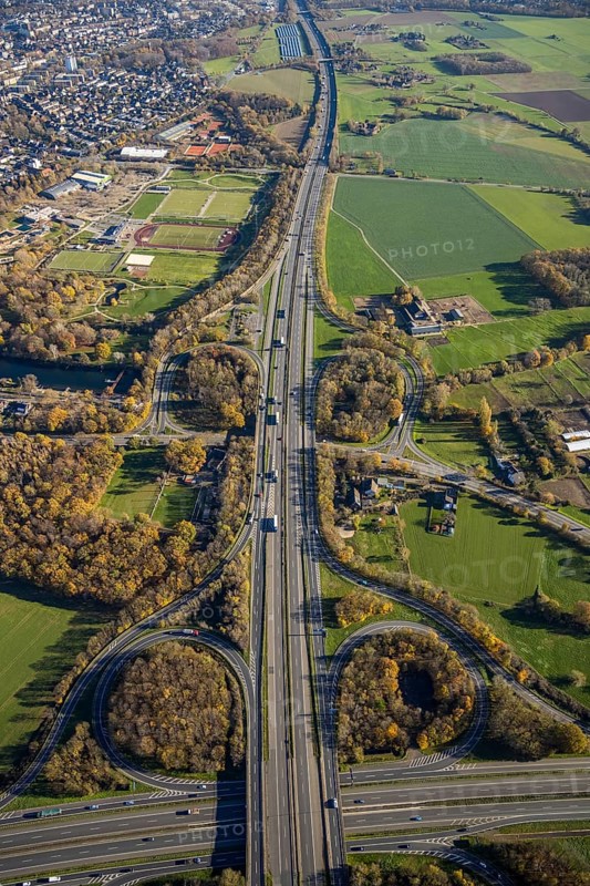 Aerial view, motorway junction Mörs, A40, A57, Moers-Hülsdonk, Mörs, Ruhr area, North Rhine-Westphalia, Germany, motorway A40, motorway A57, motorway junction, DE, Europe, shapes and colours, green trees, autumn colours, aerial view, aerial photography, aerial photography, overview, bird's-eye view, overview