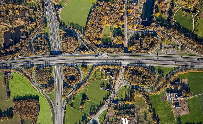 Aerial view, motorway junction Mörs, A40, A57, Moers-Hülsdonk, Mörs, Ruhr area, North Rhine-Westphalia, Germany, motorway A40, motorway A57, motorway junction, DE, Europe, shapes and colours, green trees, autumn colours, aerial view, aerial photography, aerial photography, overview, bird's-eye view, overview