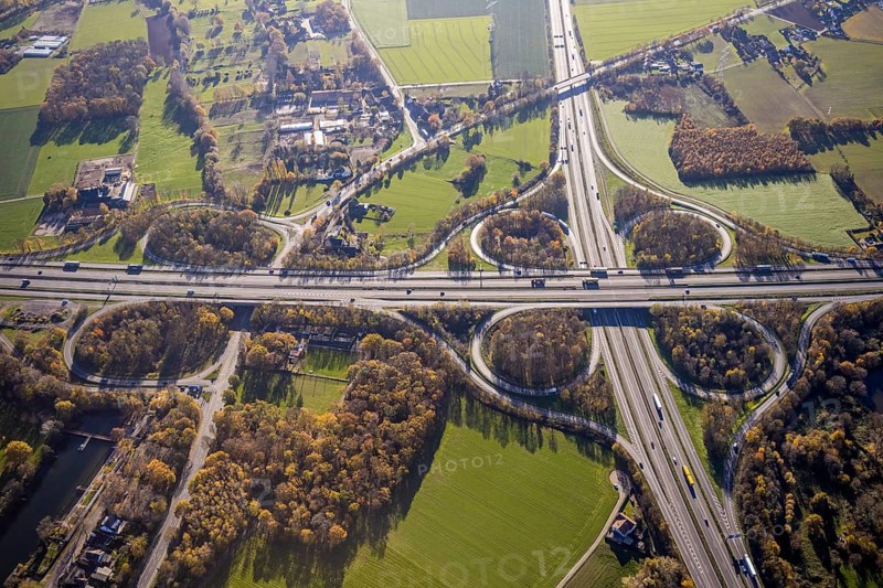 Aerial view, motorway junction Mörs, A40, A57, Moers-Hülsdonk, Mörs, Ruhr area, North Rhine-Westphalia, Germany, motorway A40, motorway A57, motorway junction, DE, Europe, shapes and colours, green trees, autumn colours, aerial view, aerial photography, aerial photography, overview, bird's-eye view, overview