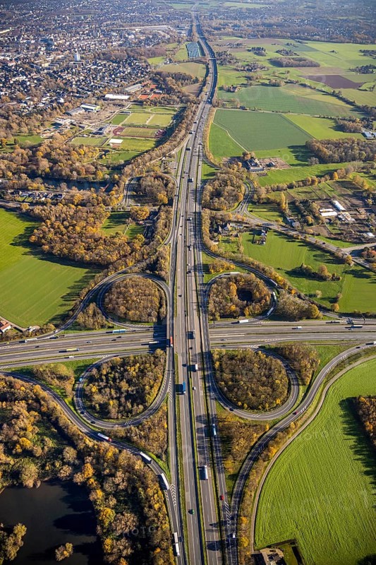 Aerial view, motorway junction Mörs, A40, A57, Moers-Hülsdonk, Mörs, Ruhr area, North Rhine-Westphalia, Germany, motorway A40, motorway A57, motorway junction, DE, Europe, shapes and colours, green trees, autumn colours, aerial view, aerial photography, aerial photography, overview, bird's-eye view, overview