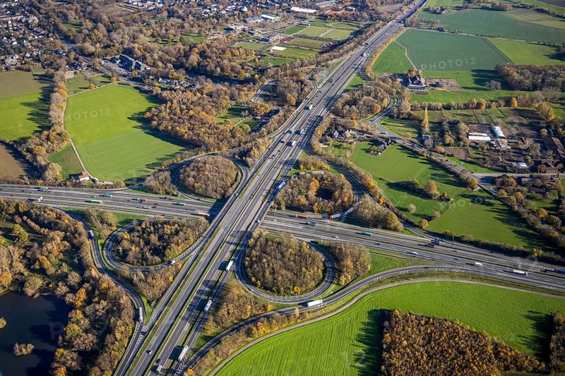 Aerial view, motorway junction Mörs, A40, A57, Moers-Hülsdonk, Mörs, Ruhr area, North Rhine-Westphalia, Germany, motorway A40, motorway A57, motorway junction, DE, Europe, shapes and colours, green trees, autumn colours, aerial view, aerial photography, aerial photography, overview, bird's-eye view, overview