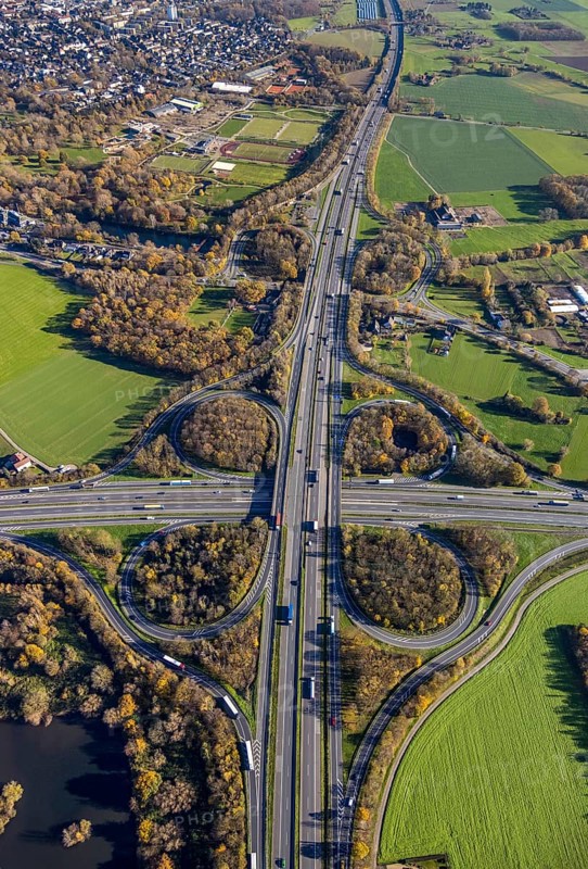 Aerial view, motorway junction Mörs, A40, A57, Moers-Hülsdonk, Mörs, Ruhr area, North Rhine-Westphalia, Germany, motorway A40, motorway A57, motorway junction, DE, Europe, shapes and colours, green trees, autumn colours, aerial view, aerial photography, aerial photography, overview, bird's-eye view, overview