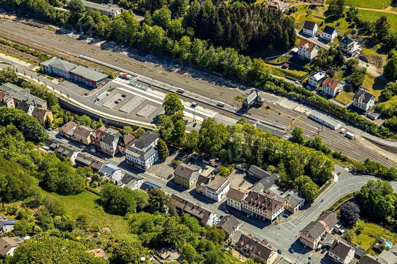 Aerial view, Brügge district, Lüdenscheid-Brügge railway station, Lüdenscheid fire brigade, Brügge equipment depot, Lüdenscheid, Märkischer Kreis, Sauerland, North Rhine-Westphalia, Germany, railway tracks, railway station, station forecourt, fire fighters, fire protection, fire watch, bridge signal box, federal road B54, DE, Deutsche Bahn AG, Europe, distant view, fire-fighting train, fire station, fire brigade, fire engine, commercial area, commercial use, property tax, green trees, real estate, district town, aerial view, aerial photography, aerial photography, fire-fighting train, tenement houses, separation station, overview, bird's eye view, Volmetal railway, living and life, residential buildings, birds-eyes view, green lung, overview