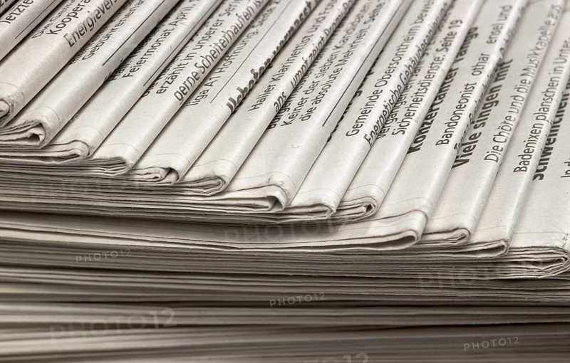 Full frame background with lots of stacked newspapers