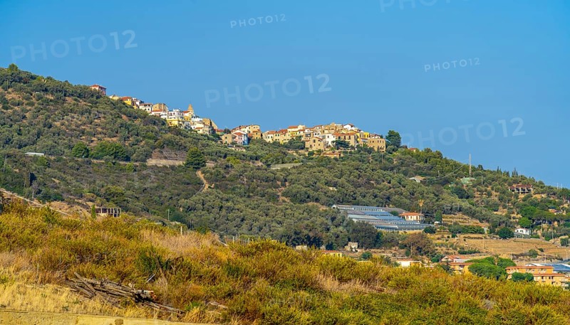 Small village on hill top seen in Liguria, Italy