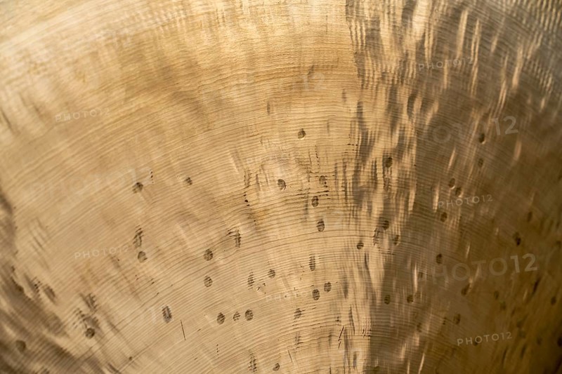 Full frame abstract closeup shot of a metallic asian gong
