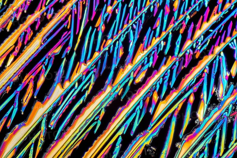 Colorful microscopic shot of Sodium nitrate microcrystals in polarized light