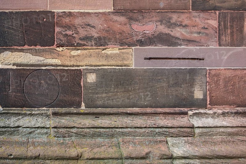 Historic engravings on a stone wall at the Freiburg Minster in Freiburg im Breisgau, a city in southern German