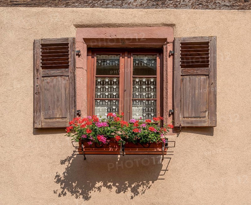 Sunny illuminated window seen in Kaysersberg, a historical town and former commune in Alsace in northeastern France