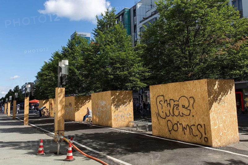 DEU Germany Germany Berlin View of the pedestrian zone on Wilmersdorfer Strasse, where the trees are covered with wood to protect them due to construction work