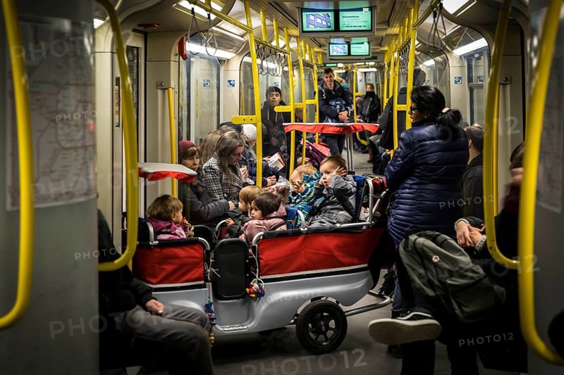 DEU Germany Germany Berlin Carer with pram for several kindergarten children in the underground