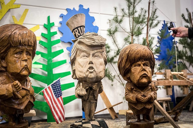 DEU Germany Germany Berlin The busts of U.S. President Donald Trump and Chancellor Angelika Merkel, made by a chainsaw artist, at the Green Week