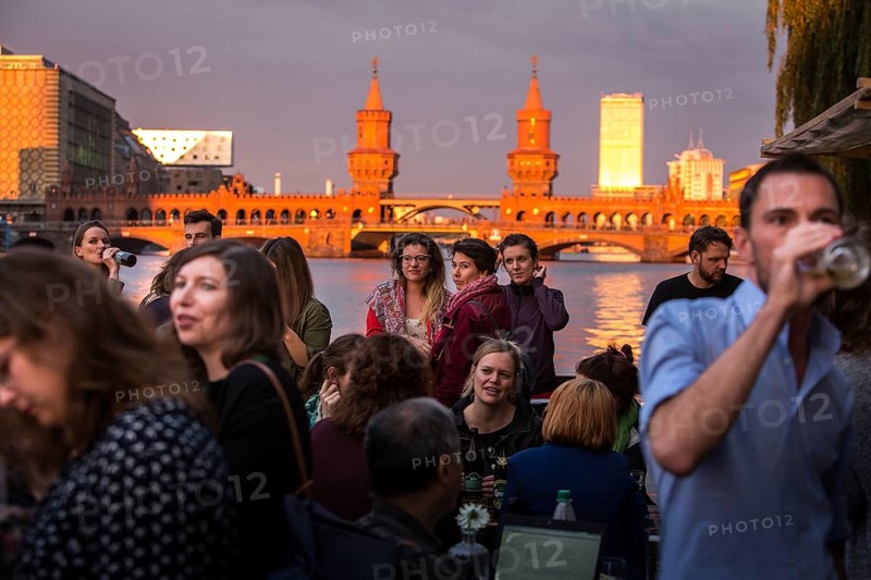 DEU Germany Germany Berlin Sunset on the terrace of the Fluxbau with the Oberbaum Bridge in the background