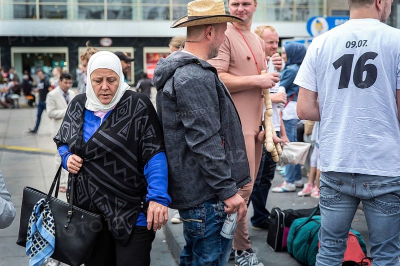 DEU Germany Germany Berlin A Muslim woman passes a young man on Alexanderplatz