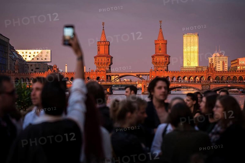 DEU Germany Germany Berlin Sunset on the terrace of the Fluxbau with the Oberbaum Bridge in the background