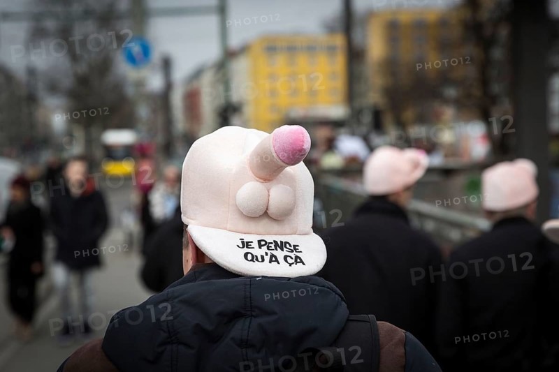 DEU Germany Germany Berlin A man wears a cap with a penis through Friedrichshain during a bachelor party