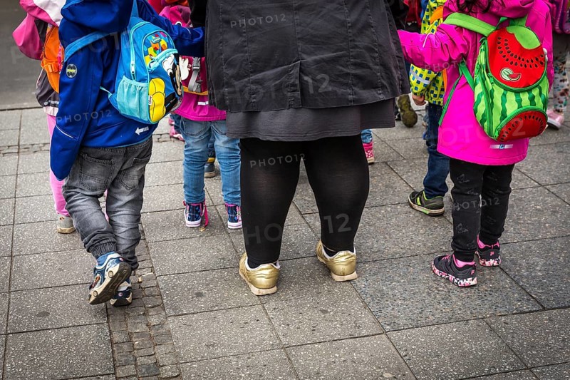 DEU Germany Germany Berlin A kindergarten teacher waits with children at a traffic light