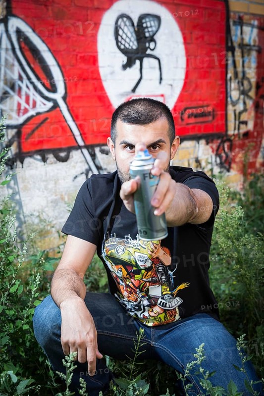 Germany Germany DEU Berlin Graffiti artist Ibo Omari in front of one of his works on a playground in Schöneberg