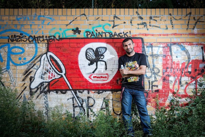 Germany Germany DEU Berlin Graffiti artist Ibo Omari in front of one of his works on a playground in Schöneberg