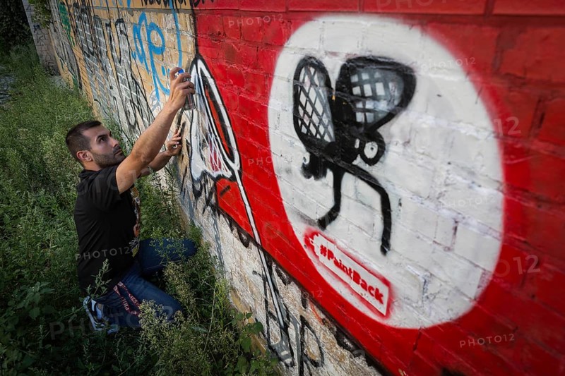 Germany Germany DEU Berlin Graffiti artist Ibo Omari in front of one of his works on a playground in Schöneberg