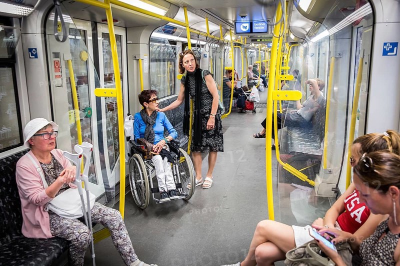DEU Germany Germany Berlin Disabled tourist in a wheelchair explores Berlin with a city guide