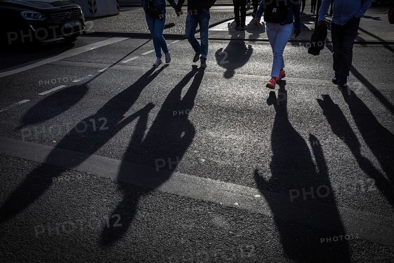 DEU Germany Germany Berlin Pedestrians cast their shadows on the street at Potsdamer Platz