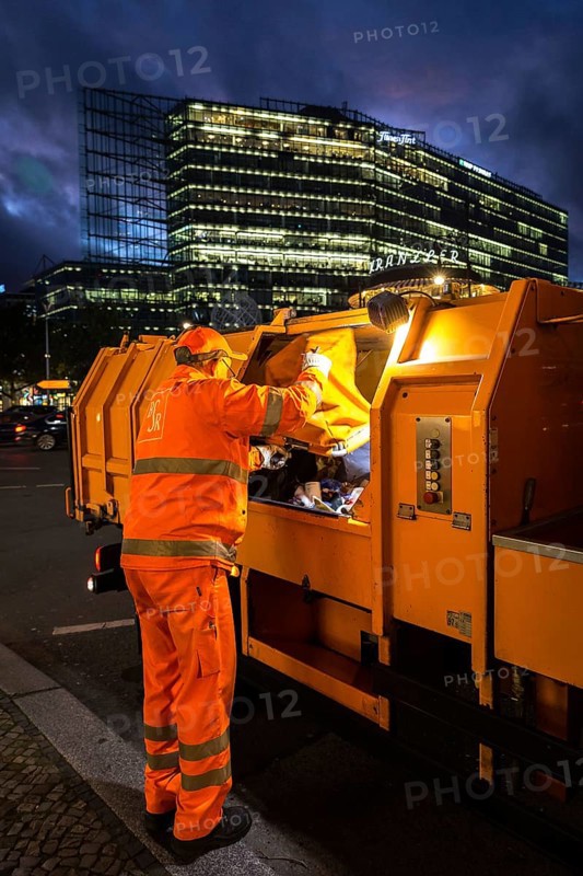 DEU Germany Germany Berlin A BSR employee unloads a rubbish bag in his vehicle on the Kudamm boulevard