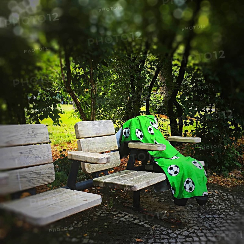 DEU Germany Germany Berlin A lonely blanket with football motifs lies abandoned on seats in a park in Wilmersdorf