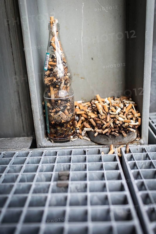 DEU Germany Germany Berlin Improvised ashtrays with cigarette butts on a balcony