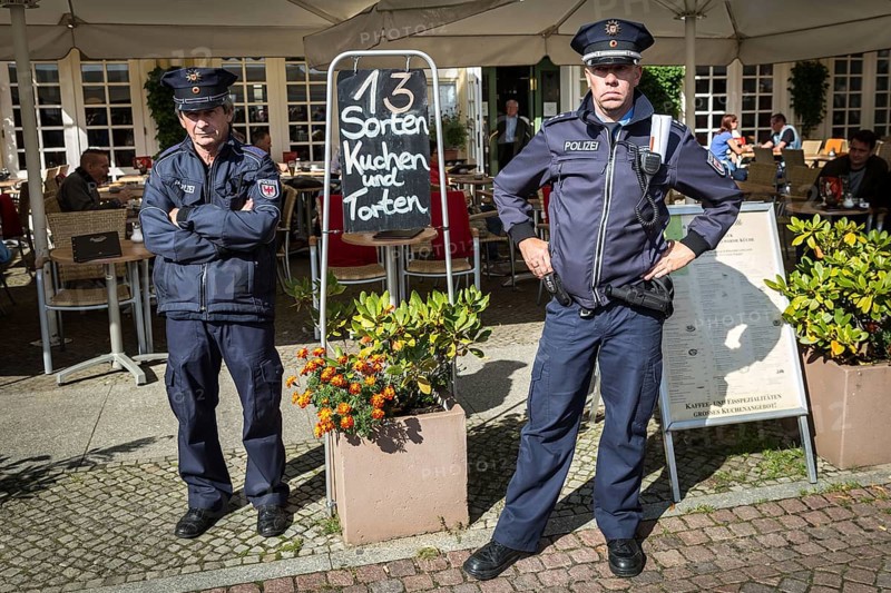 DEU Germany Germany Berlin Election campaign appearance of SPD chancellor candidate Martin Schulz. Police officers stand guard in front of a café offering 13 types of cakes and tarts
