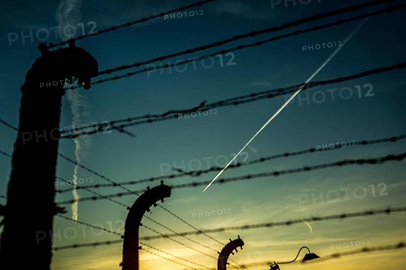 POL Poland Auschwitz Photo series about the memorial site of the former concentration camp Auschwitz-Birkenau. Condensation strips of an aeroplane over the fences of the camp. POL Poland Auschwitz Scenes at the Holocaust Memorial . A planes flies over the camp.Each year more than 2 million visitors are touring through the remains of the former German Nazi concentration and extermination camp Auschwitz-Birkenau. More than 1, 1 million people have been killed here between 1940 and 1945