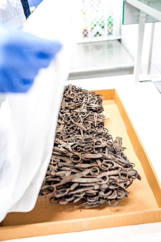 POL Poland Auschwitz Photo series about the memorial site of the former Auschwitz-Birkenau concentration camp. Processing of artefacts in the conservation laboratory. Scissors fused by fire. POL Poland Auschwitz Scenes at the Holocaust Memorial .Preserving laboratories with historic items.A block of melted scissors.Each year more than 2 million visitors are touring through the remains of the former German Nazi concentration and extermination camp Auschwitz-Birkenau. More than 1, 1 million people have been killed here between 1940 and 1945