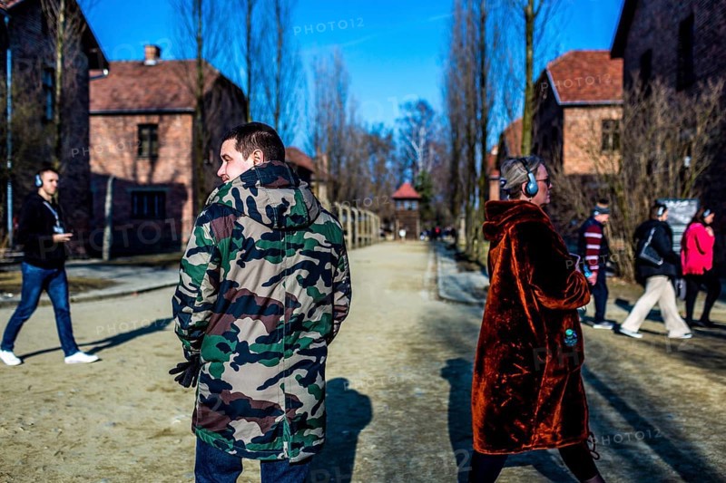 POL Poland Auschwitz Photo series about the memorial site of the former concentration camp Auschwitz-Birkenau. Visitor with camouflage jacket. POL Poland Auschwitz Scenes at the Holocaust Memorial .Visitor with camouflage jacket. Each year more than 2 million visitors are touring through the remains of the former German Nazi concentration and extermination camp Auschwitz-Birkenau. More than 1, 1 million people have been killed here between 1940 and 1945