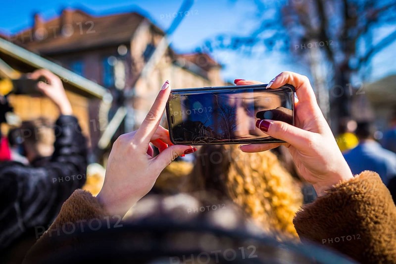 POL Poland Auschwitz Photo series about the memorial site of the former concentration camp Auschwitz-Birkenau. Visitor takes a mobile phone photo at the entrance. POL Poland Auschwitz Scenes at the Holocaust Memorial .A girl photographs in front of the entrance.Each year more than 2 million visitors are touring through the remains of the former German Nazi concentration and extermination camp Auschwitz-Birkenau. More than 1, 1 million people have been killed here between 1940 and 1945