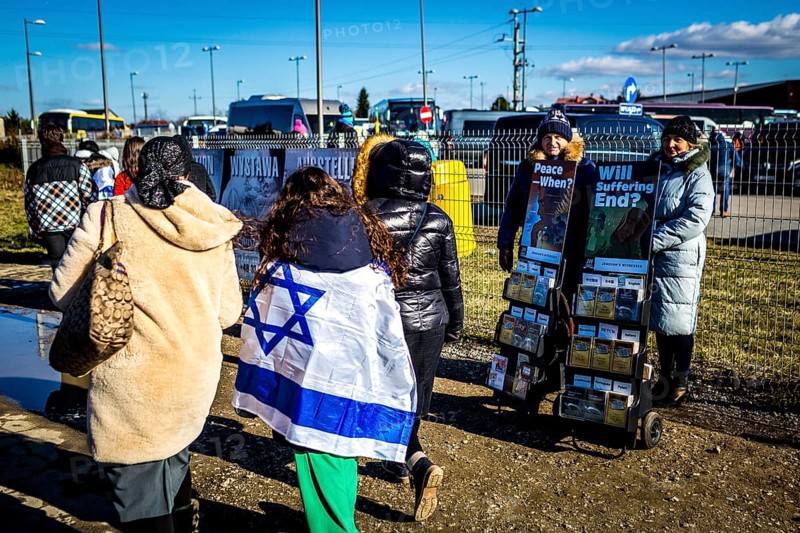 POL Poland Auschwitz Photo series about the memorial site of the former Auschwitz-Birkenau concentration camp. Israeli visitors with their flags passing Jehovah's Witnesses stand. POL Poland Auschwitz Scenes at the Holocaust Memorial .Israeli visitors with their flags passing Jehovah's witnesses.Each year more than 2 million visitors are touring through the remains of the former German Nazi concentration and extermination camp Auschwitz-Birkenau. More than 1, 1 million people have been killed here between 1940 and 1945